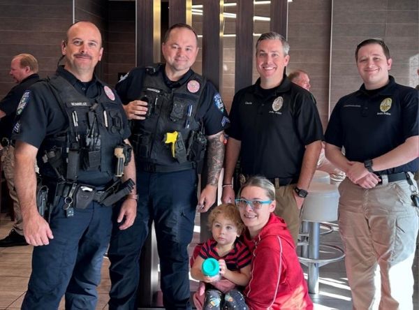 Department Member standing with a mother and her child